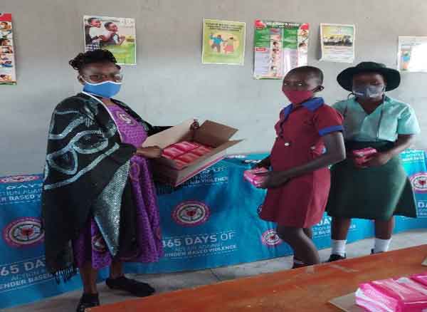 A Gurungweni primary pupil in maroon dress receiving sanitary ware couldn’t hide her smile under the mask ….by her side is a student form Mhlanguleni secondary receiving sanitary ware.